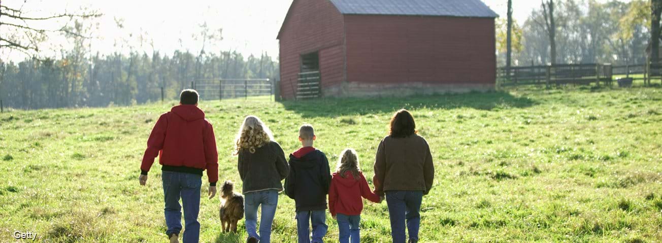 Farm family walking towards barn