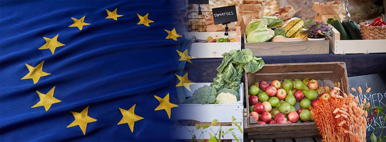 European Union flag next to fresh produce and grains