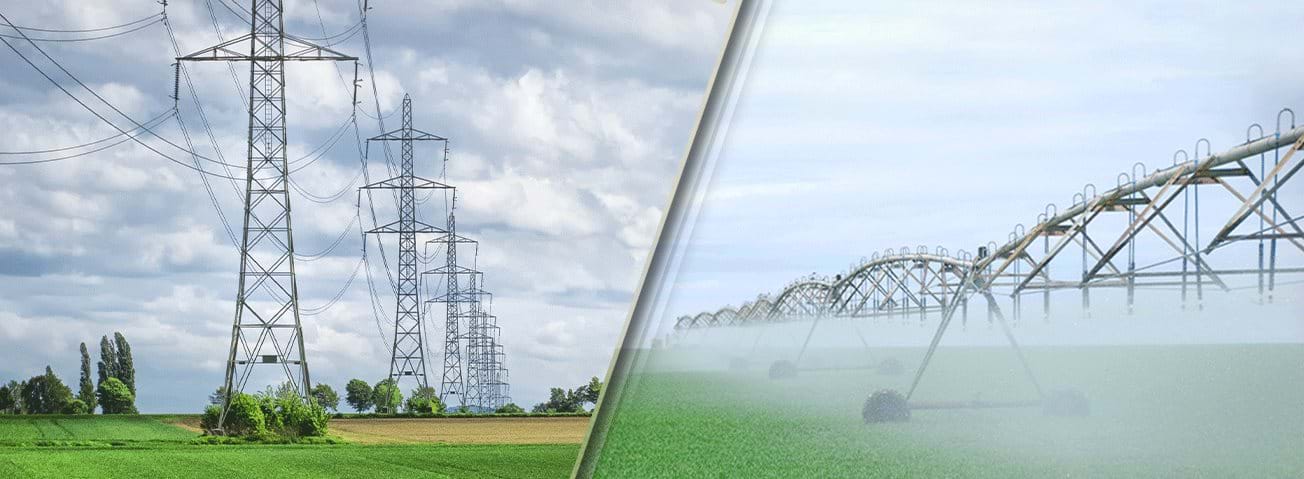 Electric pylons crossing a field on the left and a pressurized irrigation system on the right.