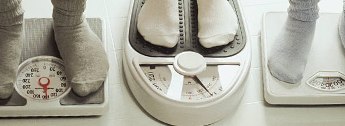 A photo of stockinged feet on scales